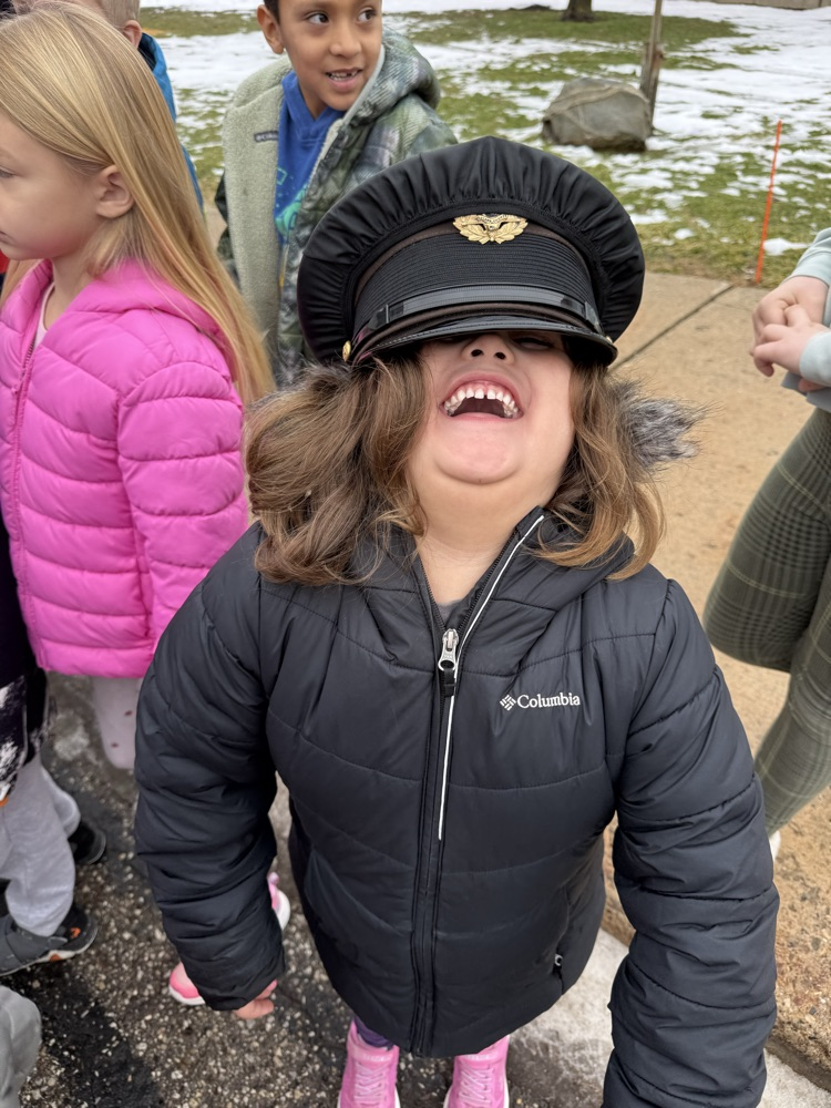 student trying on police hat