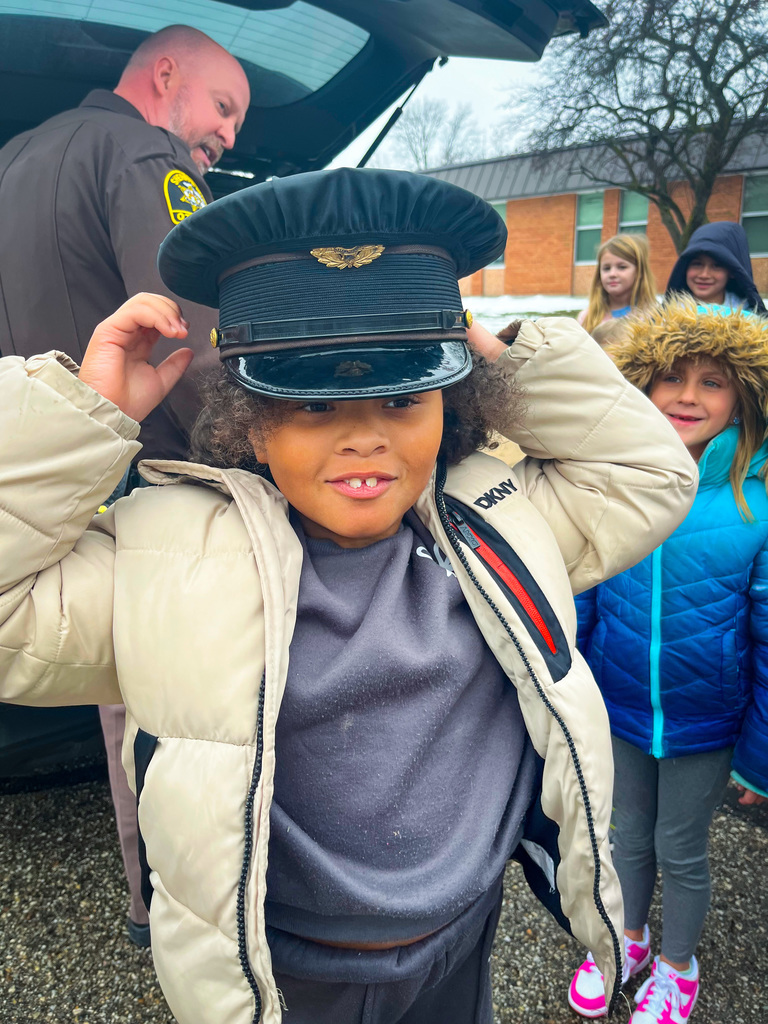Student trying on police cap