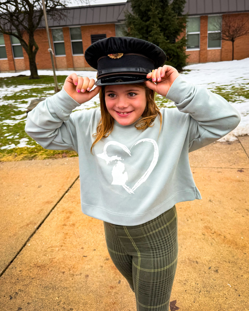 Student trying on police cap