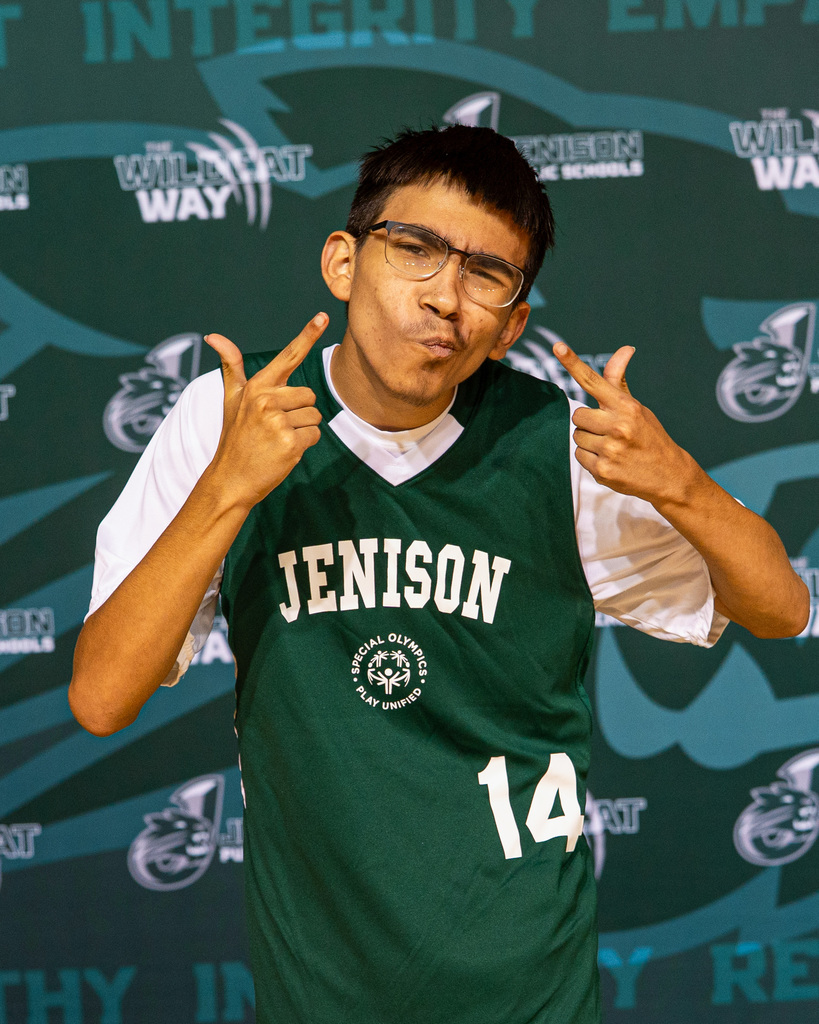 Unified basketball players posing in jerseys