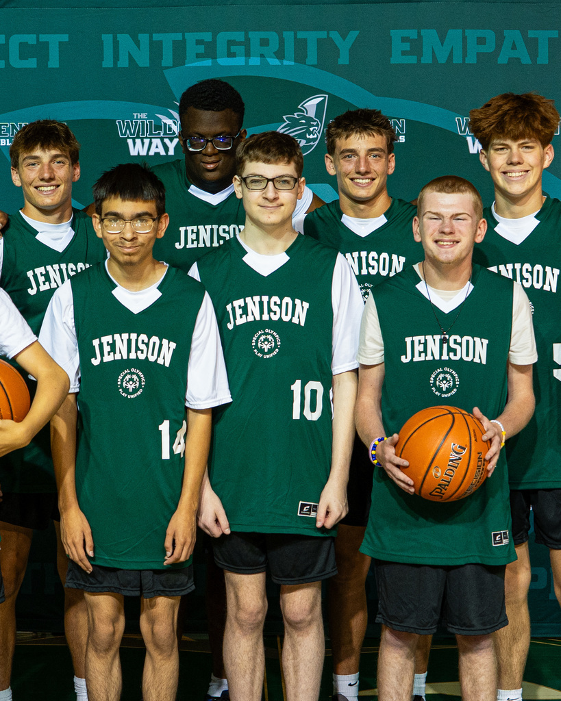 Unified basketball players posing in jerseys