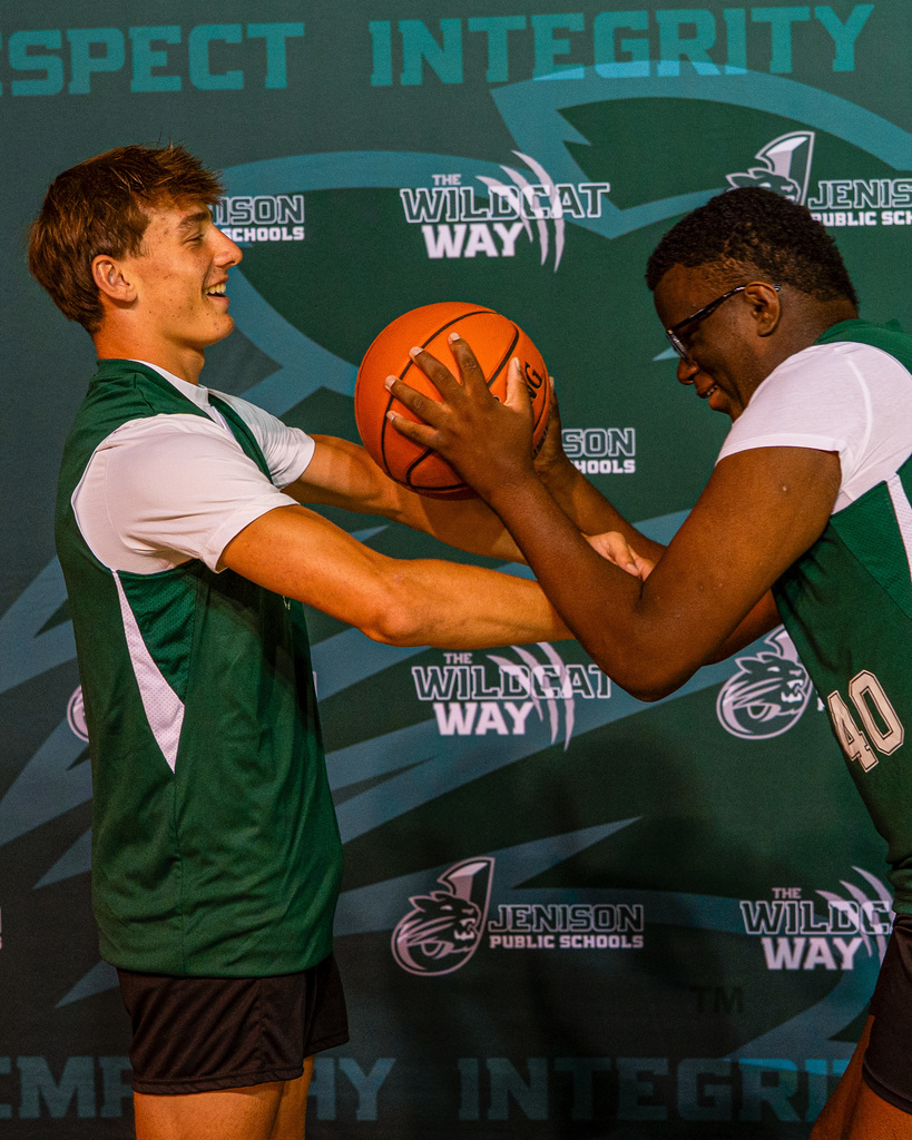 Unified basketball players pretending to shoot a hoop