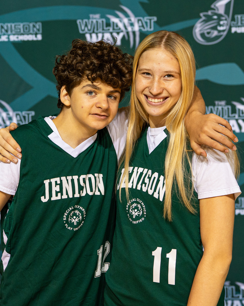 Unified basketball players posing in jerseys