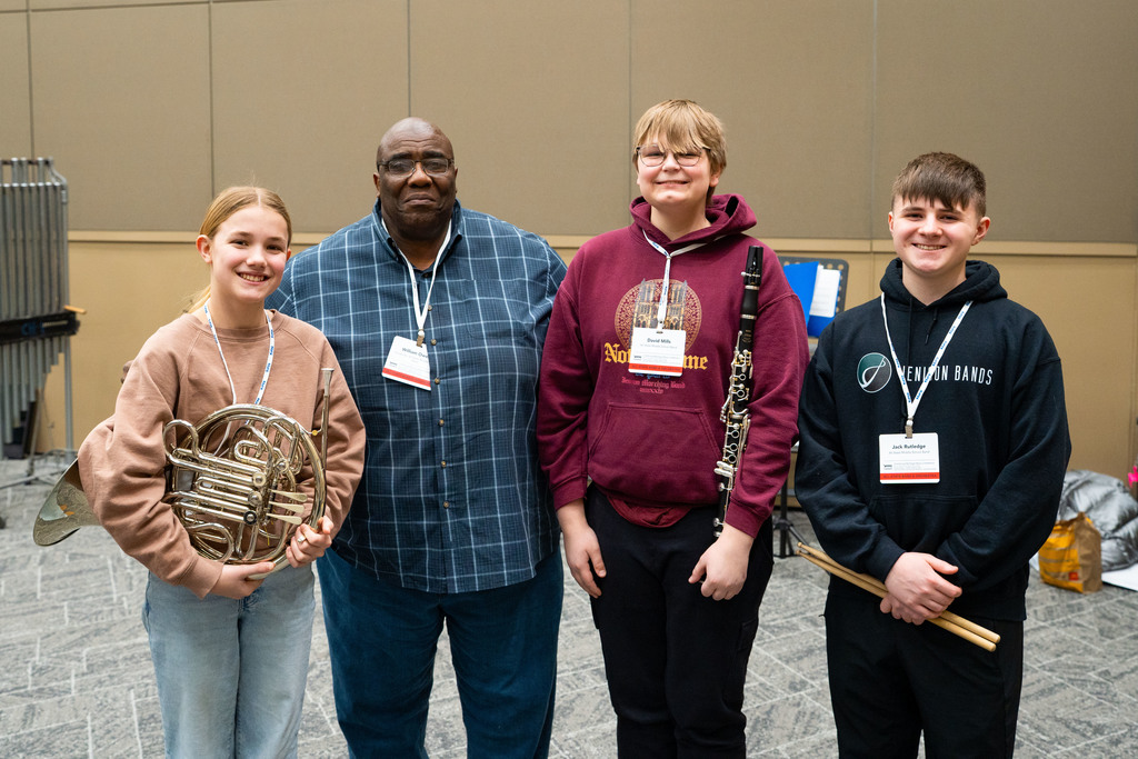 Students posing with conductor 