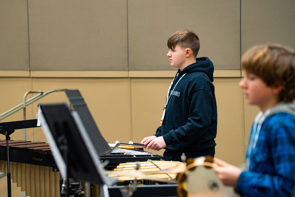 Student playing percussion in all state band