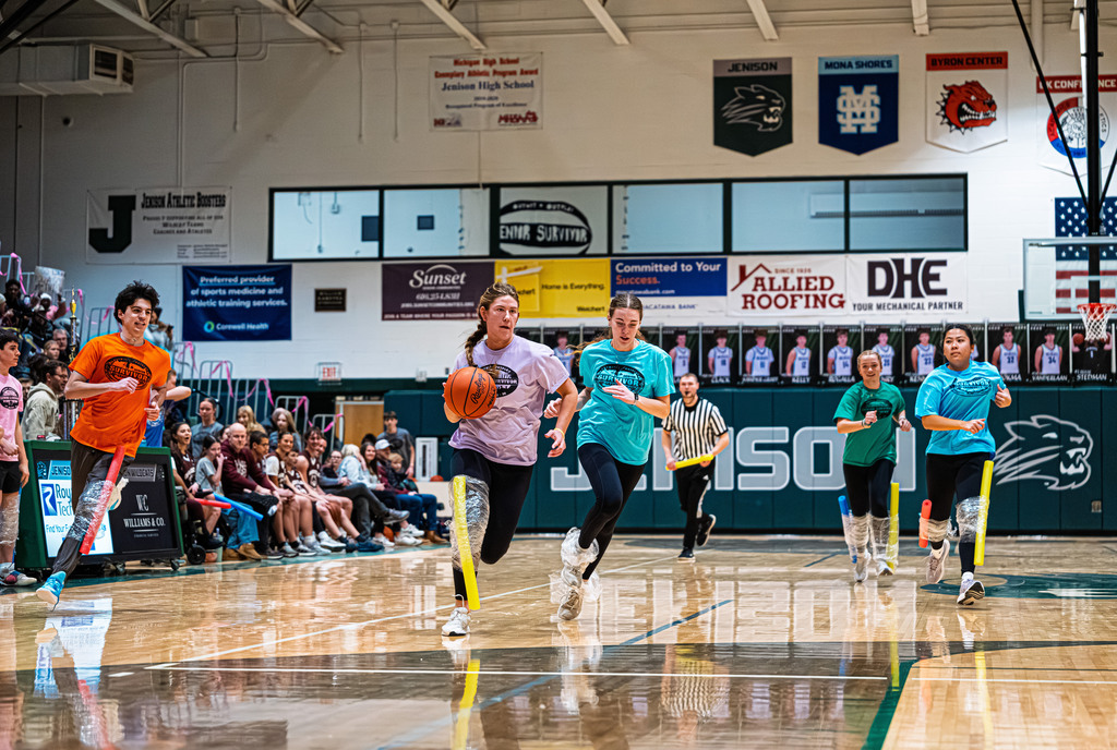 Student dribbling down the court
