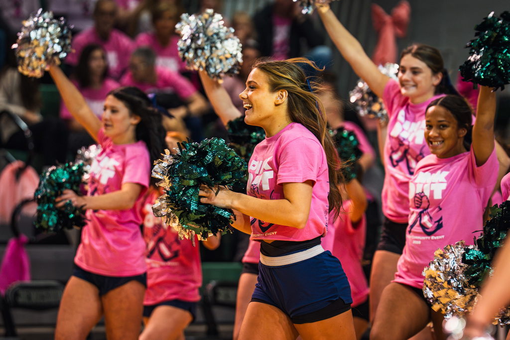 Cheer team smiling and arriving on court