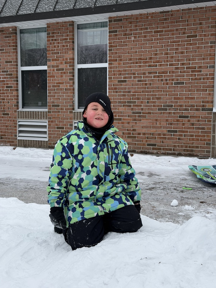 student smiling in snow  