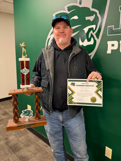 Joe smiling with award