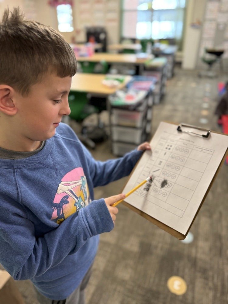 student showing clipboard  