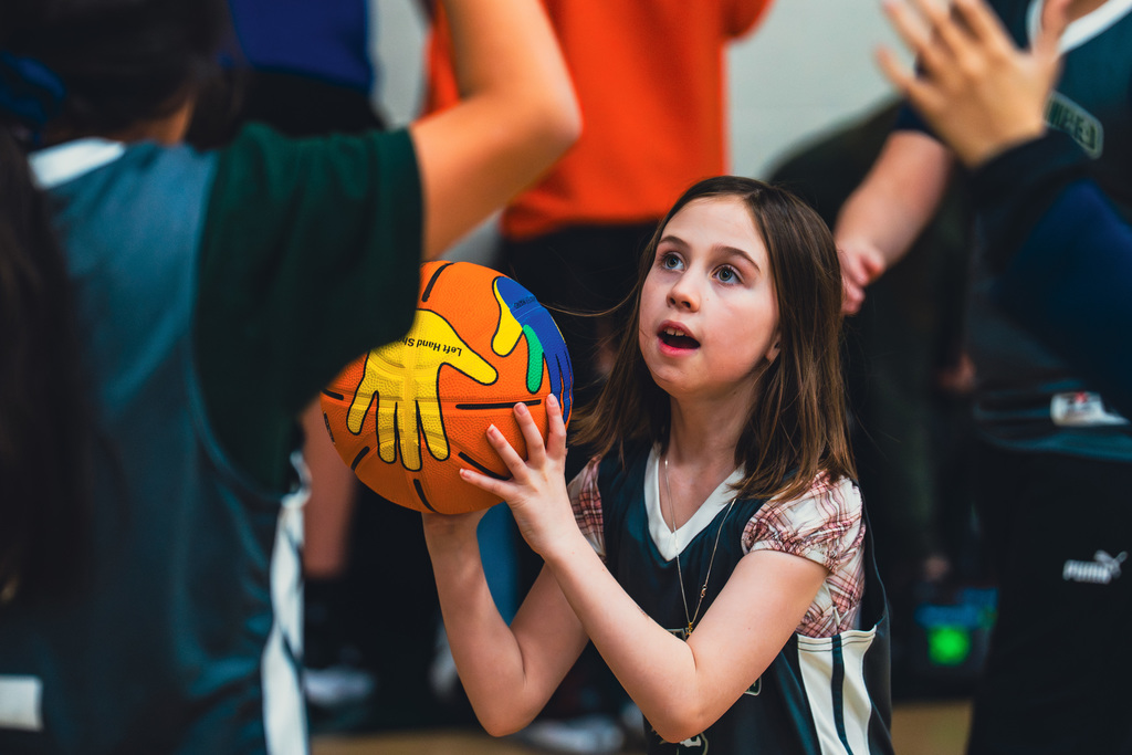 Elementary Unified student shooting a basket