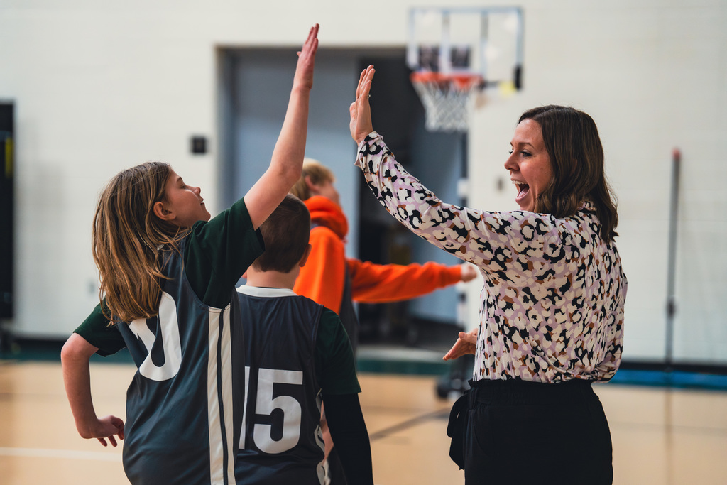 Unified coach high fiving a student