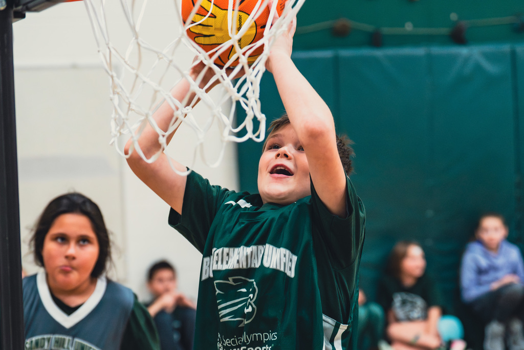 Elementary Unified student shooting a basket