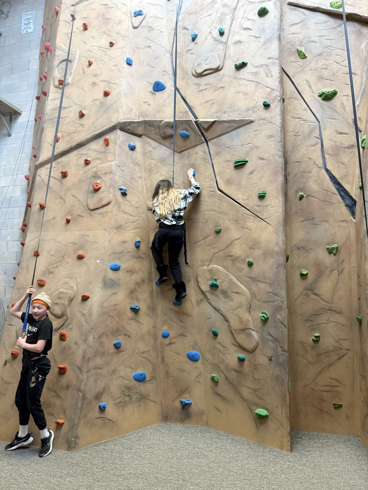 student on a climbing wall