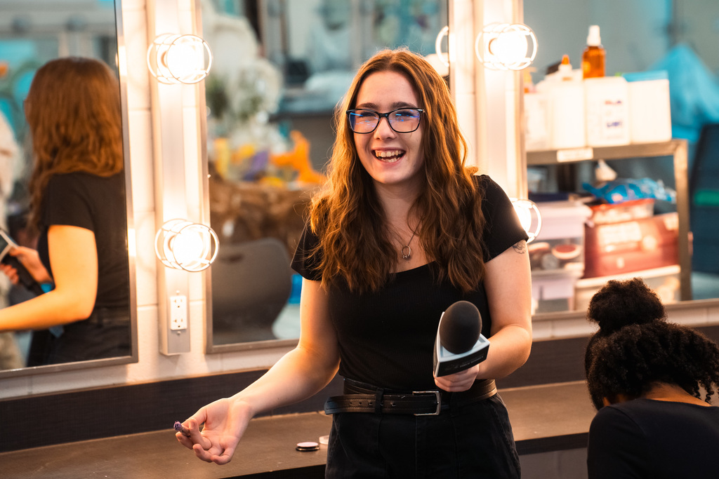 Theater student smiling in makeup room