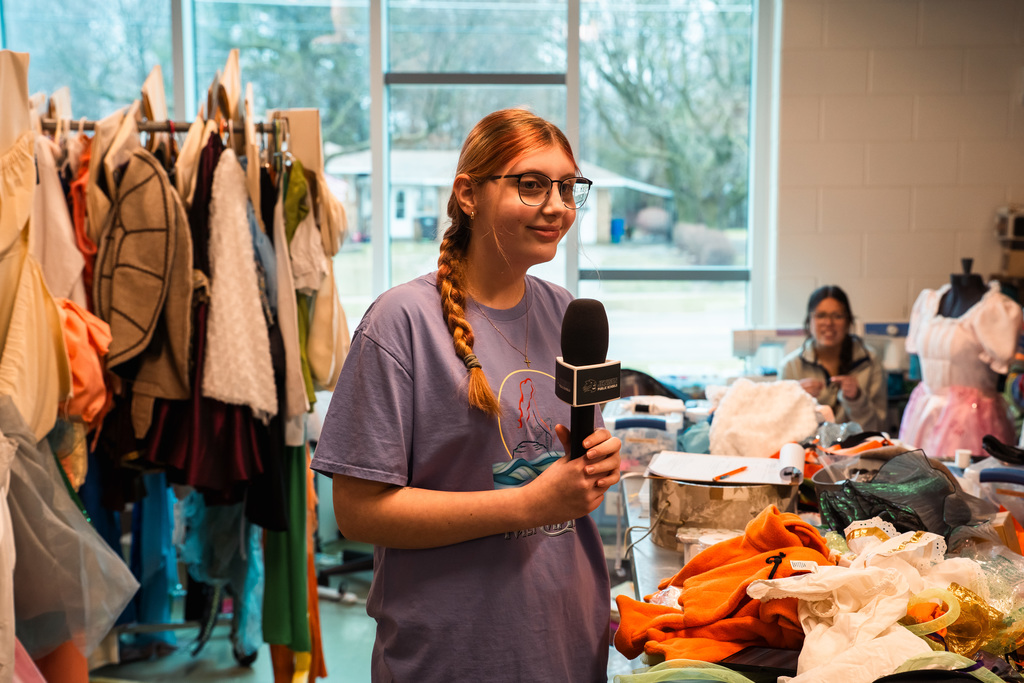 Theater student talking in costume shop