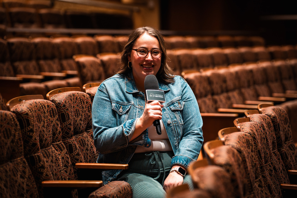 Theater director smiling in chair