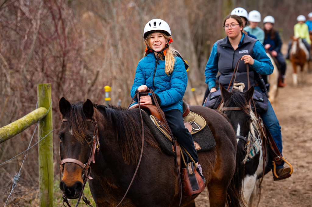 Student riding horses