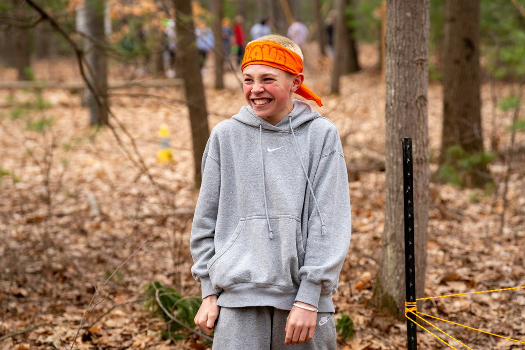 Student smiling on obstacle course