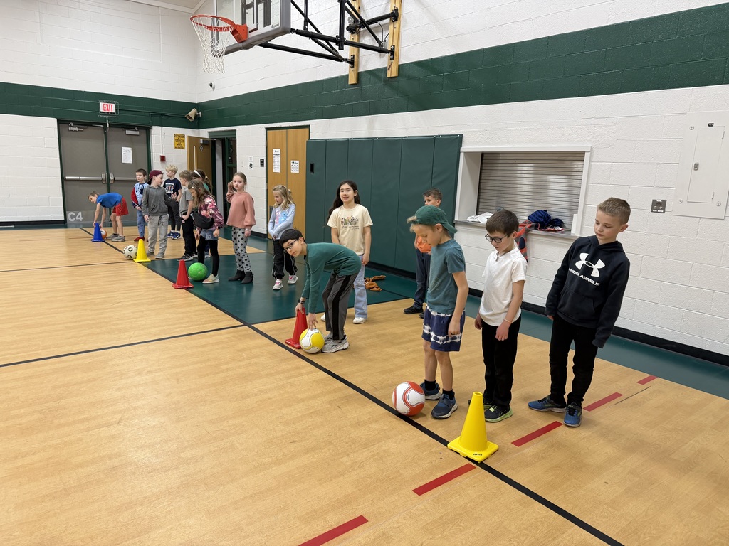 Students line up for the dribbling relay race in a recent Elective Experience Physical Education rotation.