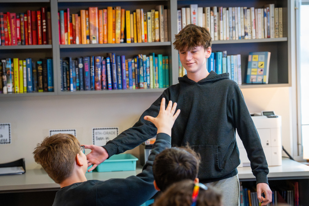Student high fiving classmate
