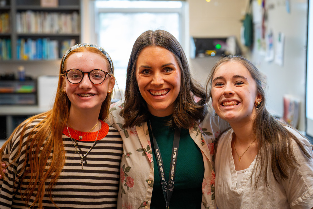 Teacher posing with students