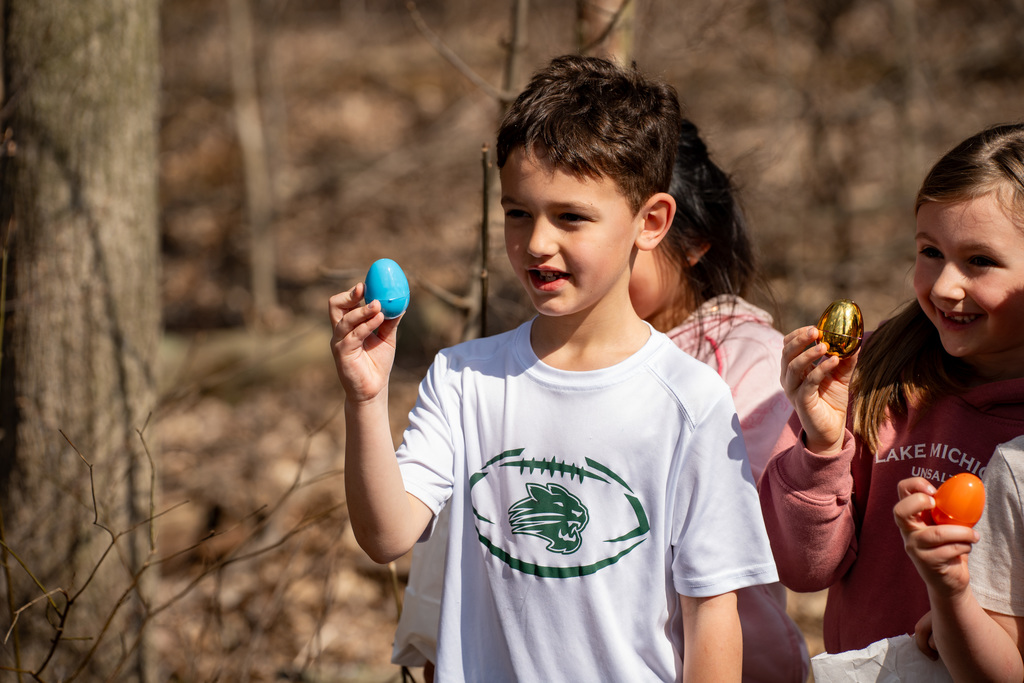 Student smiling during egg hunt