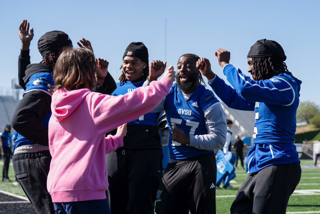 Unified students dancing with football team