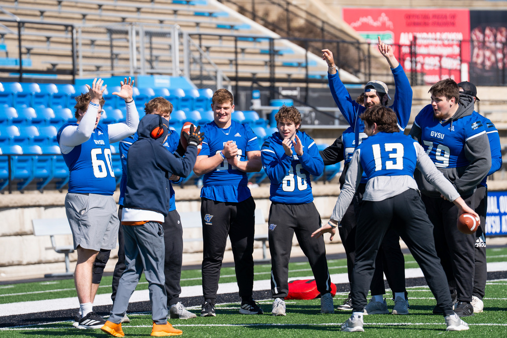 Jenison Unified student scores touchdown with football player cheering