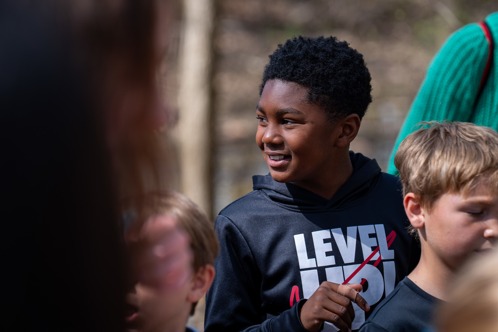 Elementary student smiling near river