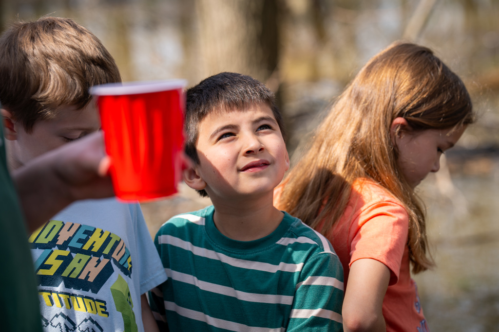 Elementary student smiling near river