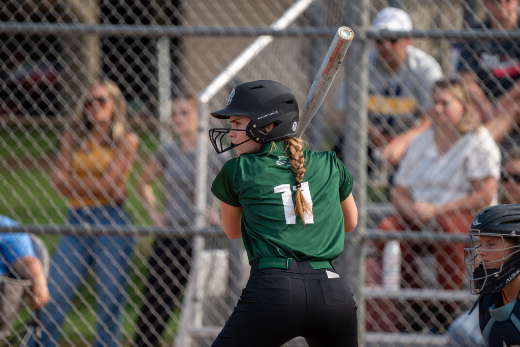 Softball player swinging the bat