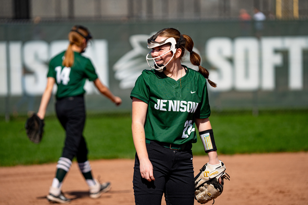 Softball player smiling on third base
