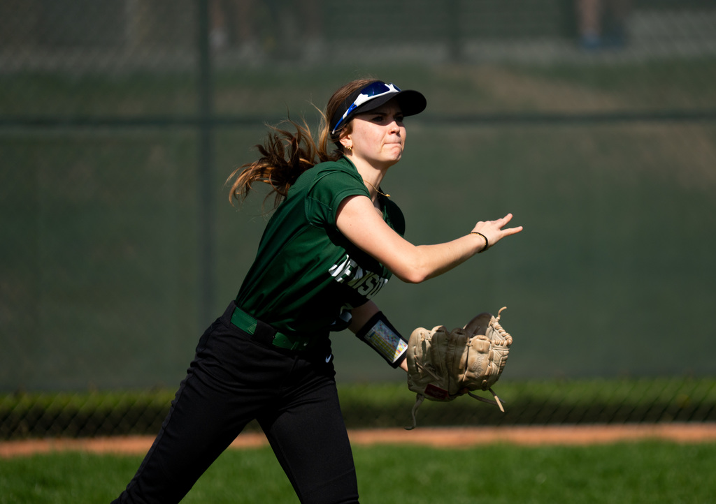 Softball outfielder throwing the ball to infield