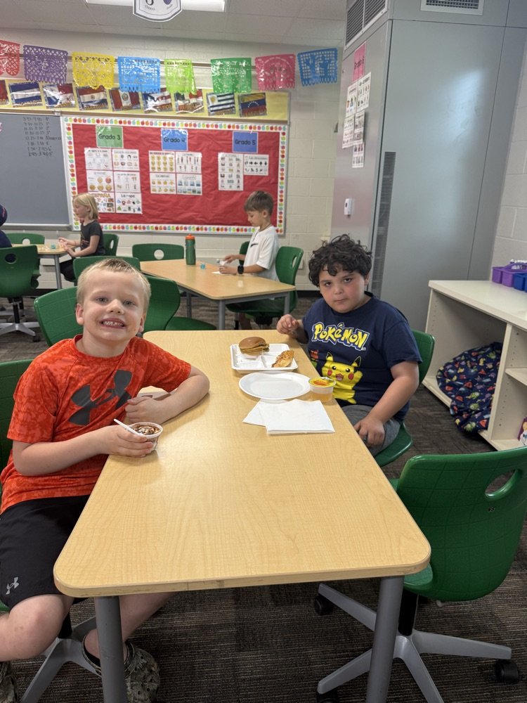 students smiling and eating pizza
