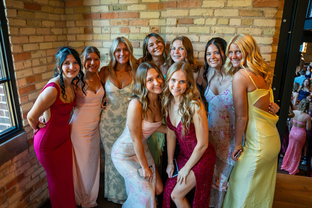 Group of girls posing on red carpet at prom
