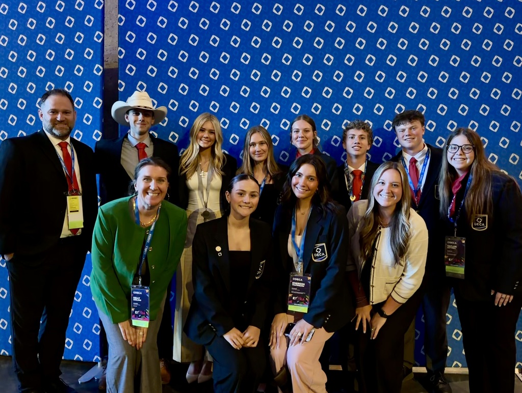 DECA students posing with staff in Atlanta