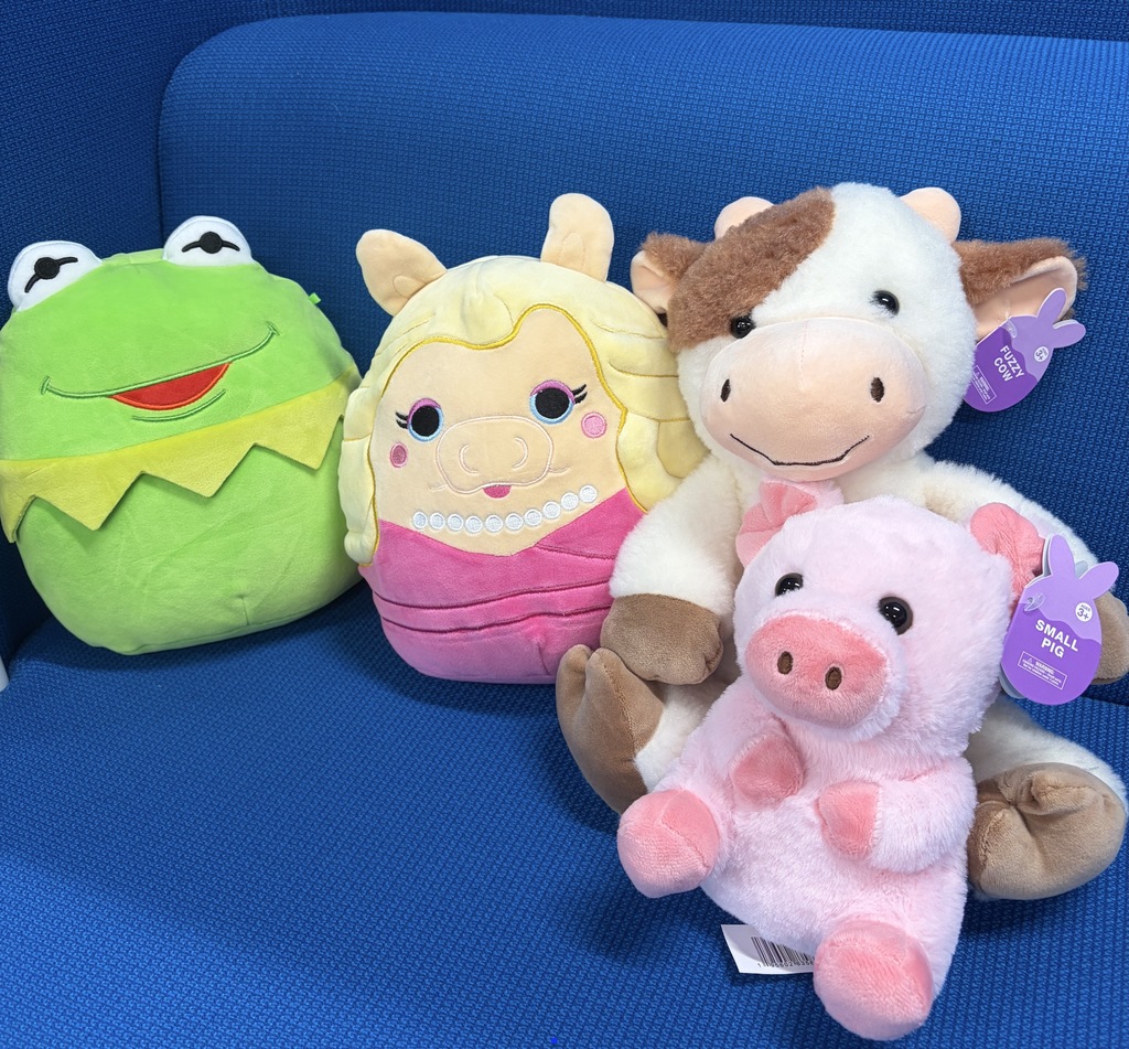 A close up of stuffed animals on a blue chair.