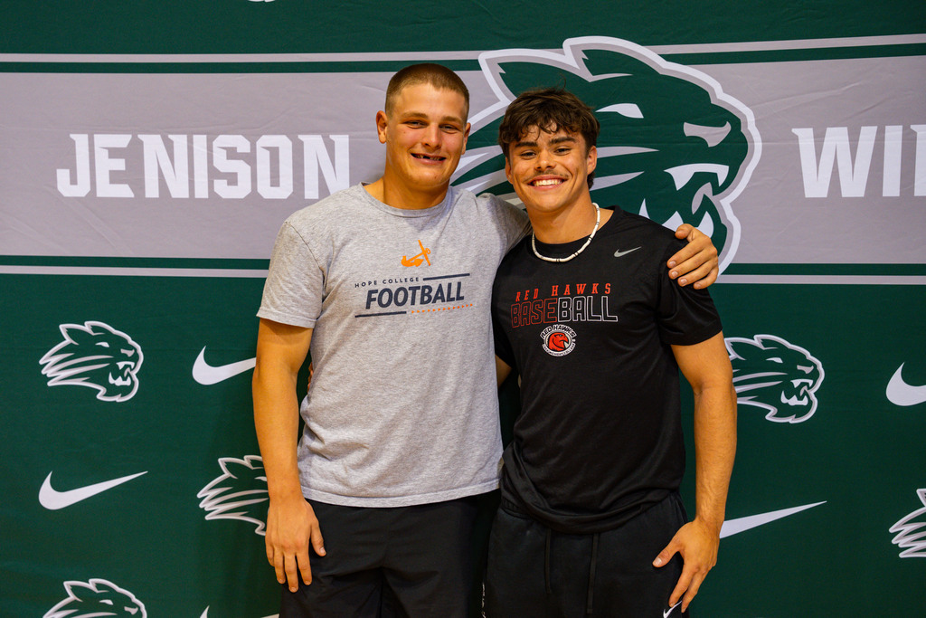 Football players posing with Jenison backdrop