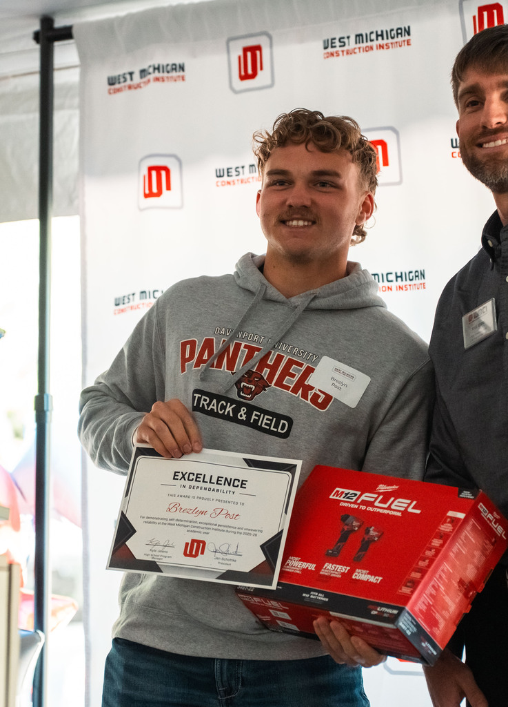 Construction student posing with award