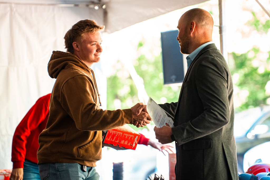 Construction student shaking hands with official 