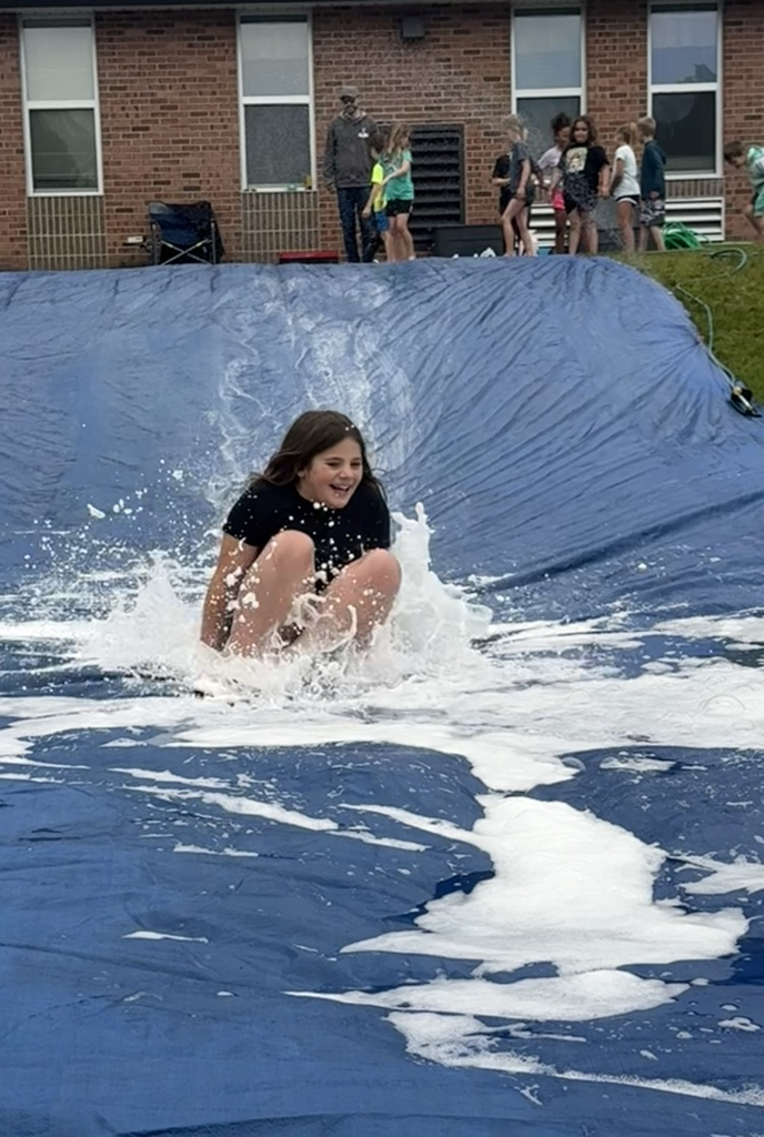 student on slip n slide