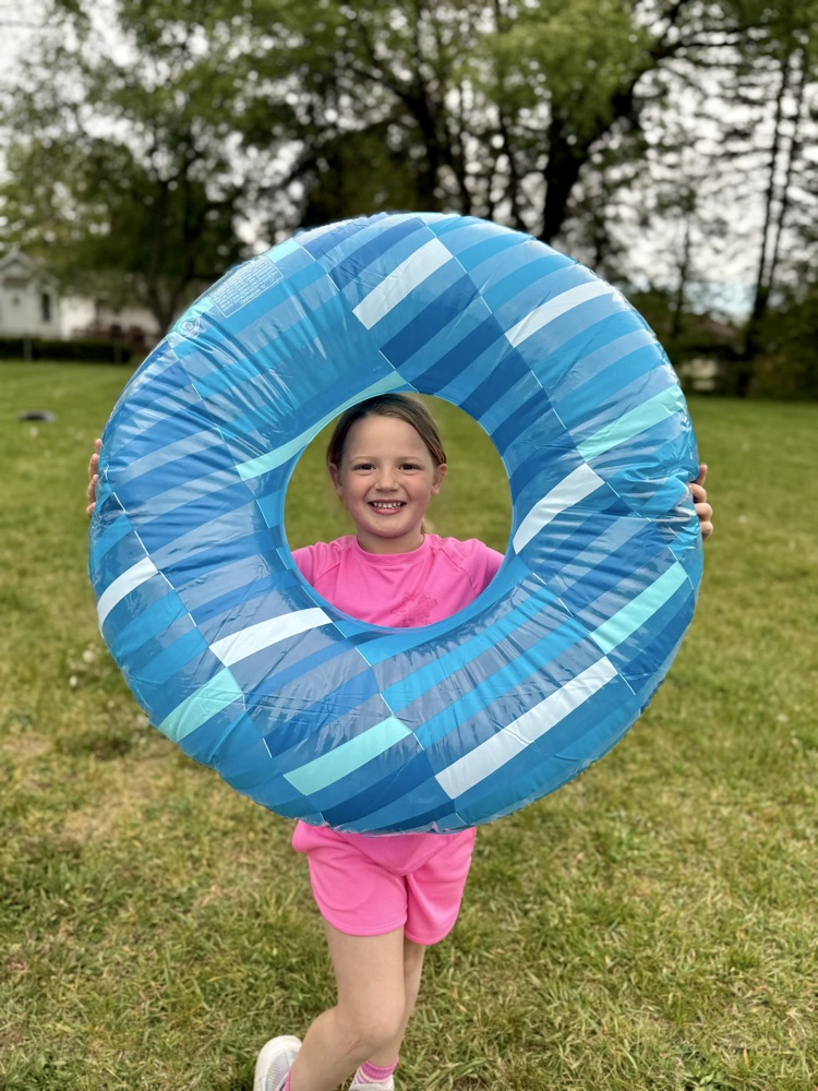 student smiling with inner tube