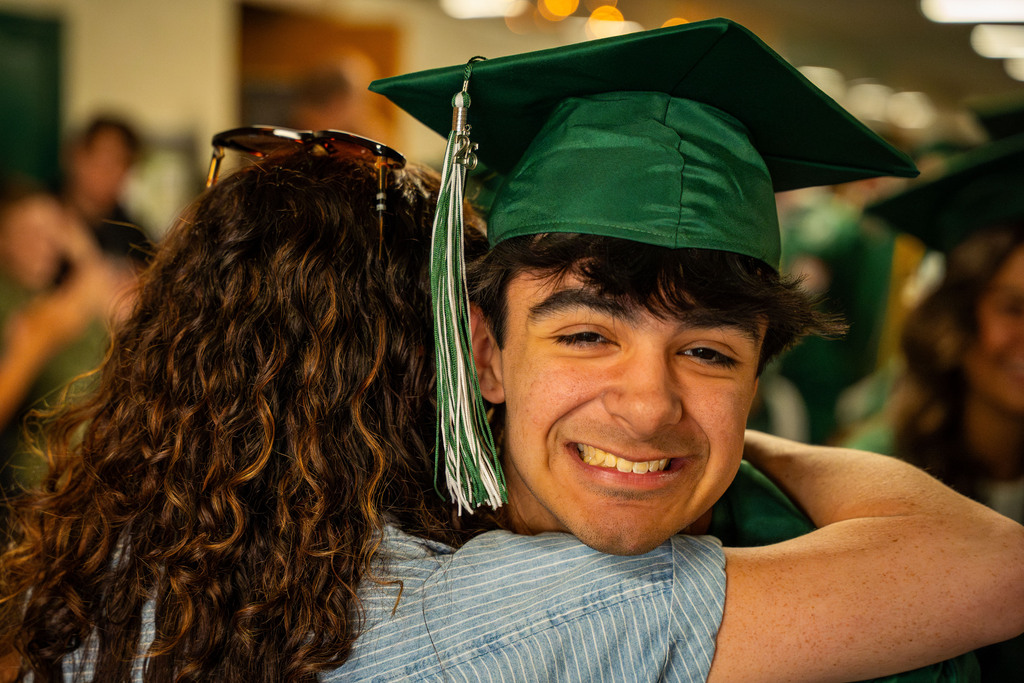 Seniors hugging staff