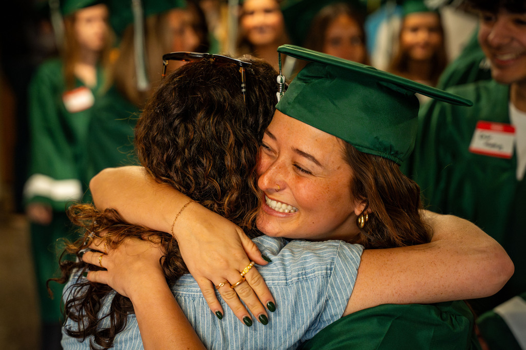 Seniors hugging staff