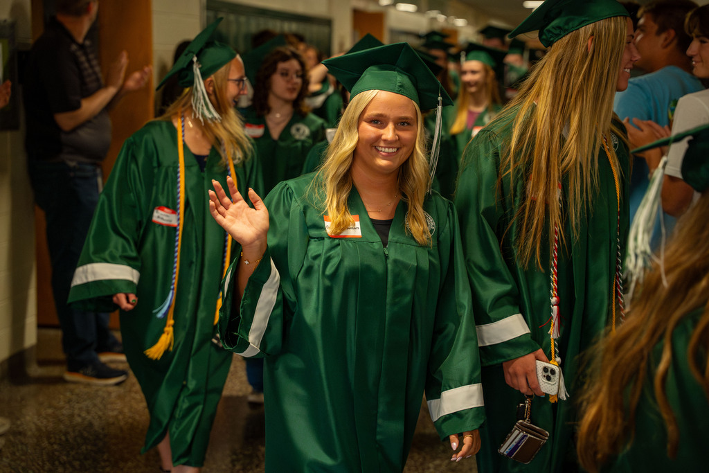 Senior waving to students