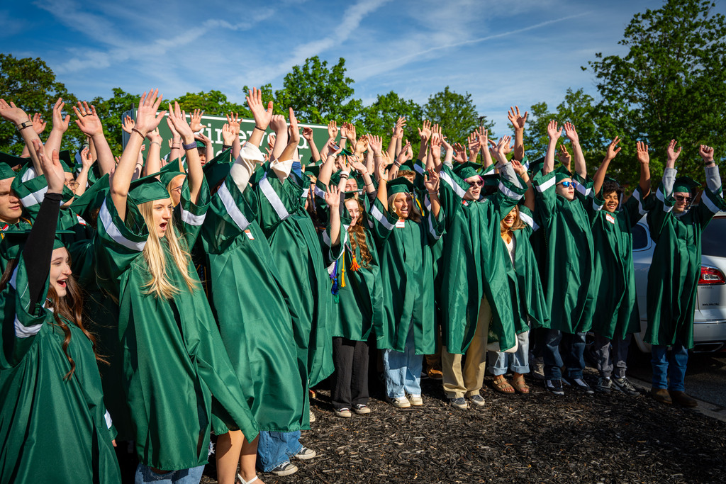 Seniors waving in front of school