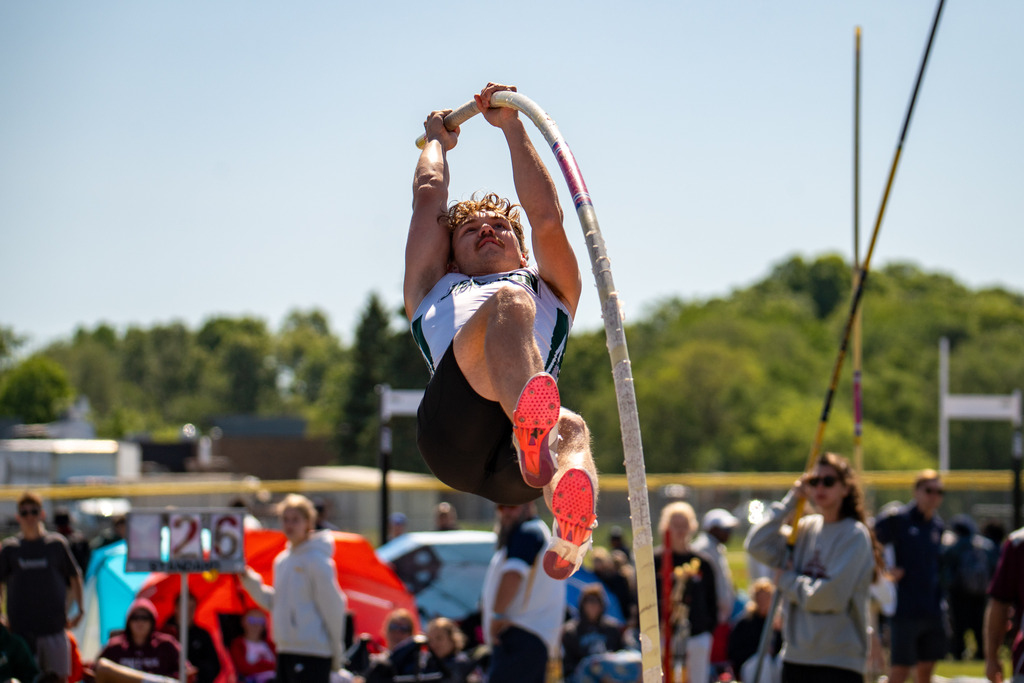 Jenison boys pole vaulter flying through air