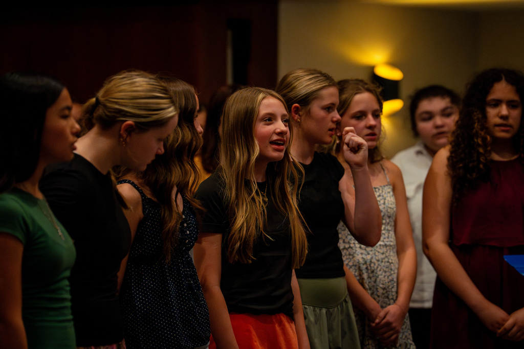 Girls choir member singing with a smile