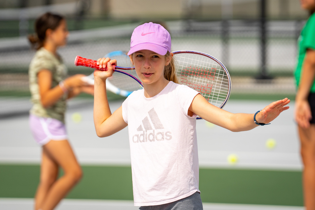 Jenison Tennis camp girl smiling and dancing